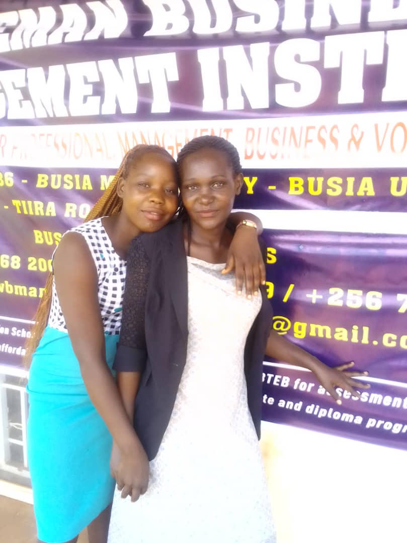Learners standing in front of a Wiseman banner