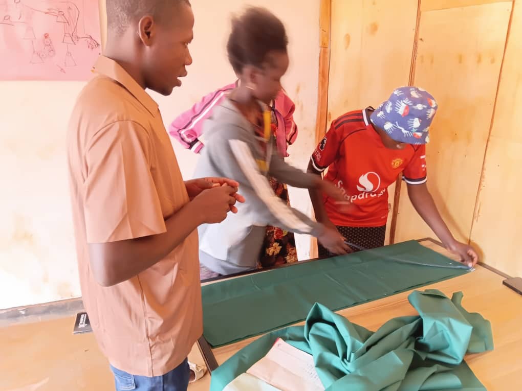 Learners practicing tailoring and garment cutting
